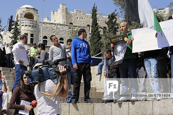 Palestinians demonstrating peacefully with placards and posters against the Israeli settlement policy in front of a camera at the Damascus Gate outside the Old City  Jerusalem  Israel  Middle East  Southwest Asia