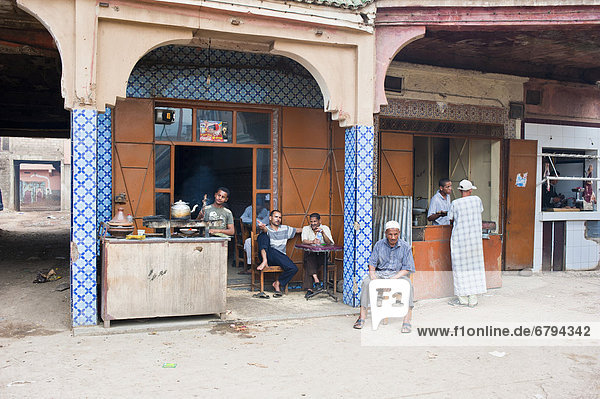 Mehrere Männer an einem Verkaufsstand und Straßenrestaurant  Marokko  Afrika