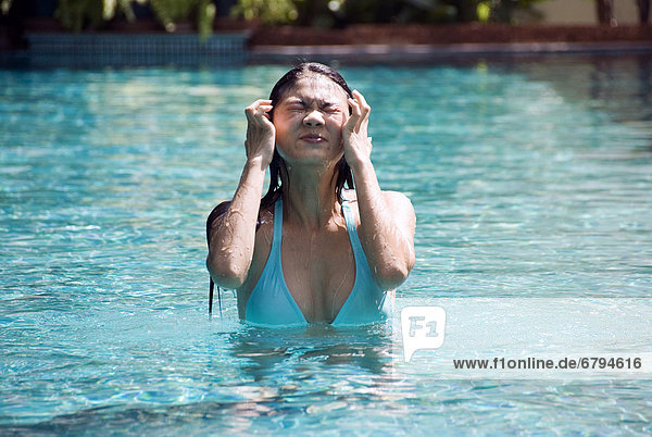 Thailand  Bangkok  Thai woman in swimming pool.