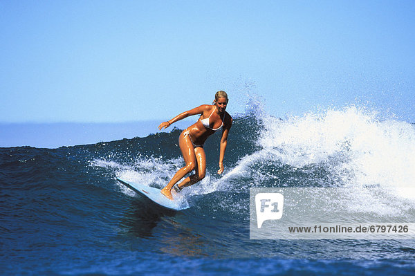 Surfer girl  Jessica Bishop riding a wave