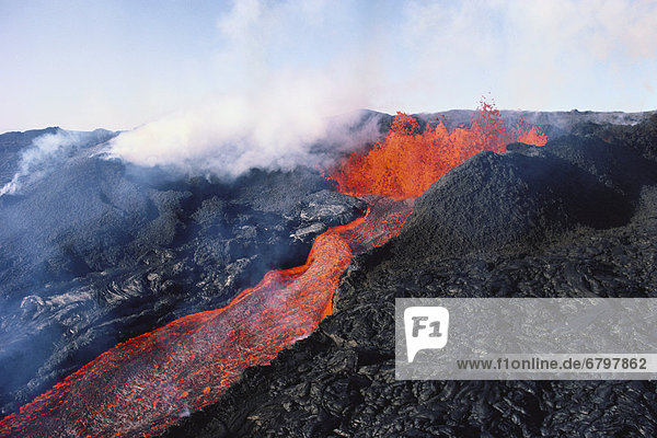 Hawaii  Big Island  Hawaii Volcanoes National Park  Mauna Loa eruption  lava flowing  steam rising.