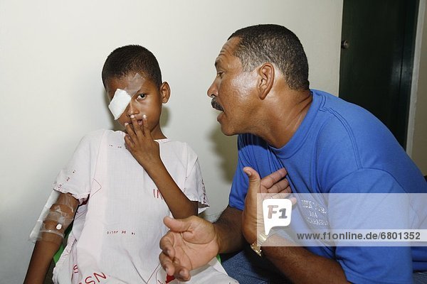 Bluefields  Nicaragua  Man Talking To Sick Boy
