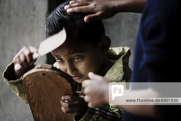 Orphaned Boy In Orphanage Combing His Hair  Pokhara  Nepal