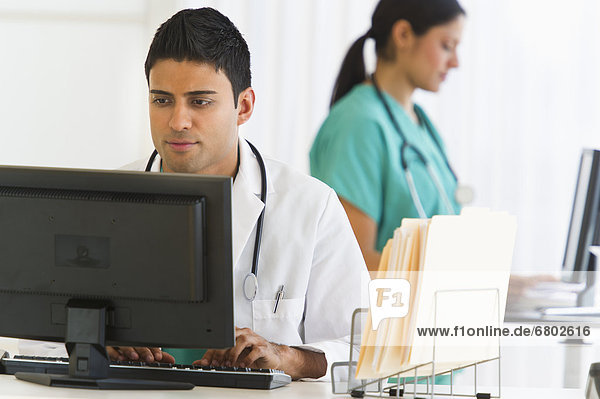 Doctors working on computers