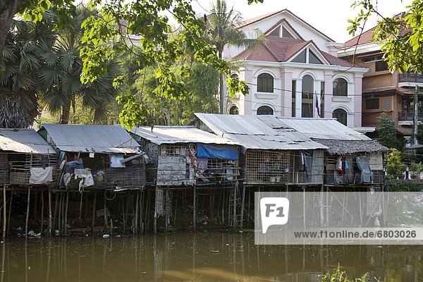Poor And Wealthy Homes Together Along Riverbank  Siem Reap Cambodia