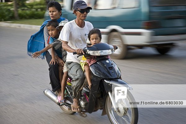 Siem Reap Cambodia Family Riding On A Scooter Together Without Safety Helmets