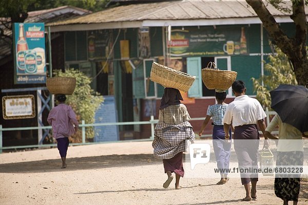 Women Walking To Market With Baskets On Their Heads  Bagan Myanmar