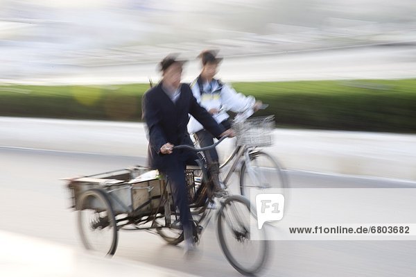 Two People Riding Bicycles