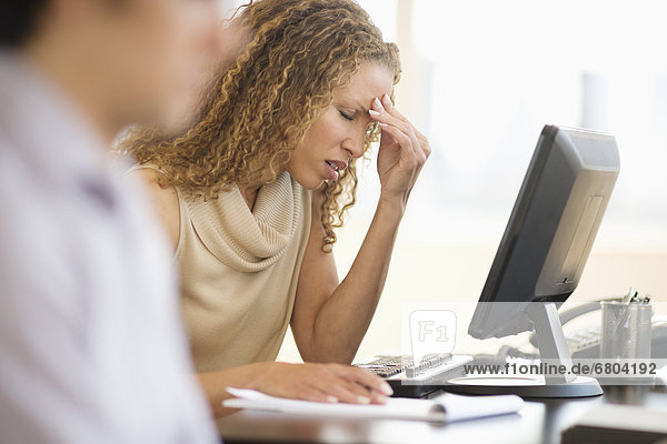 Business woman having headache in office