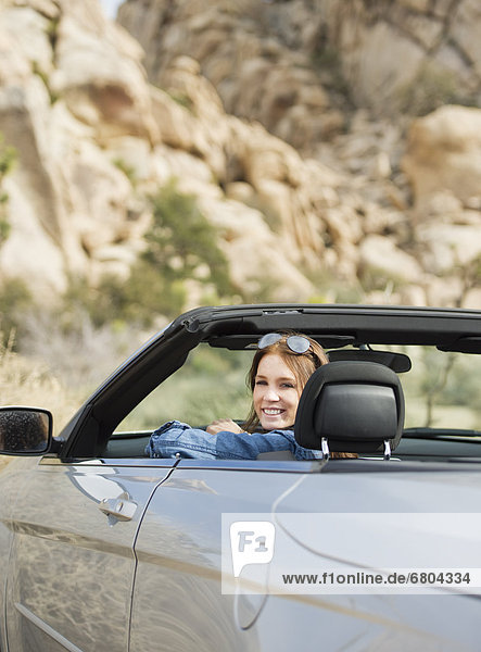 USA  California  Joshua Tree National Park  Young woman driving convertible