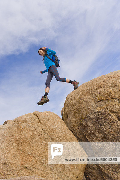 USA  California  Joshua Tree National Park  Female hiker on rocks