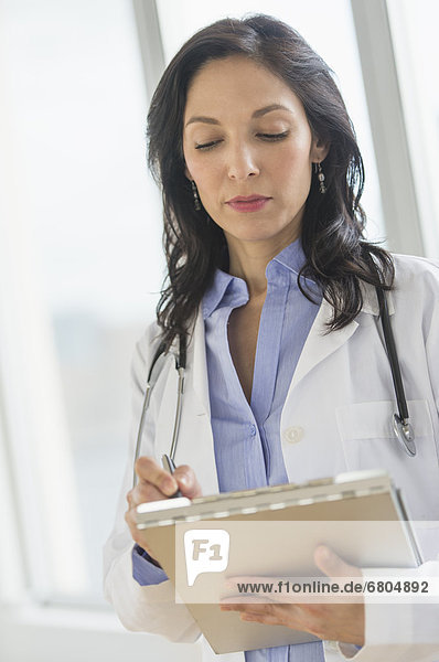 Female doctor holding medical document