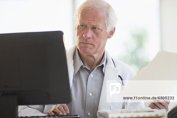 Male doctor working on computer