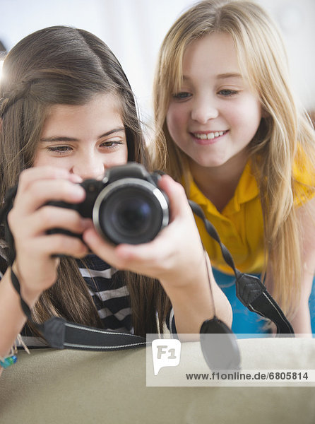 Close up of two girls using camera
