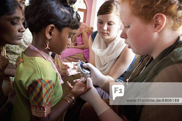 A Nurse Checks The Blood Sugar Level Of A Girl With Diabetes  Sathyamangalam  Tamil Nadu  India