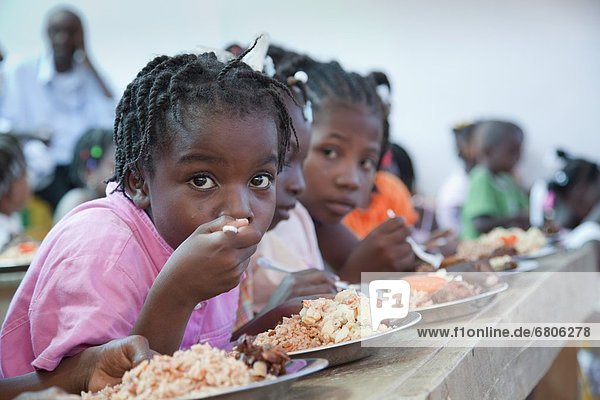 A Group Of Children Eating A Hot Meal  Port-Au-Prince  Haiti