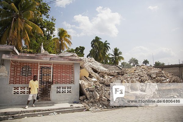 A Man Stands Beside The Ruins Of A Collapsed Building From The Earthquake  Port-Au-Prince  Haiti