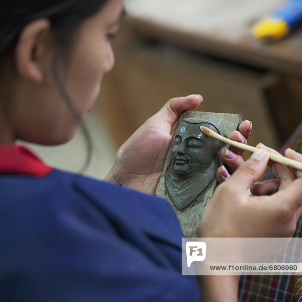 A Woman Works On A Sculpture Of A Human Face  Thimphu Thimphu District Bhutan