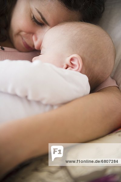 Mother and baby boy (2-5 months) sleeping together