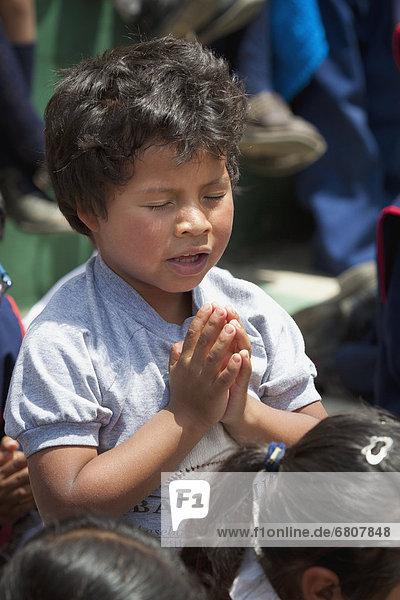 A young boy praying  antigua guatemala