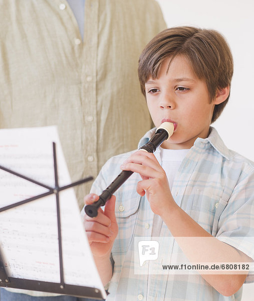 Boy (10-11 years) playing flute