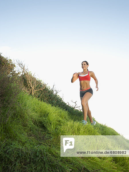 Woman training on hill
