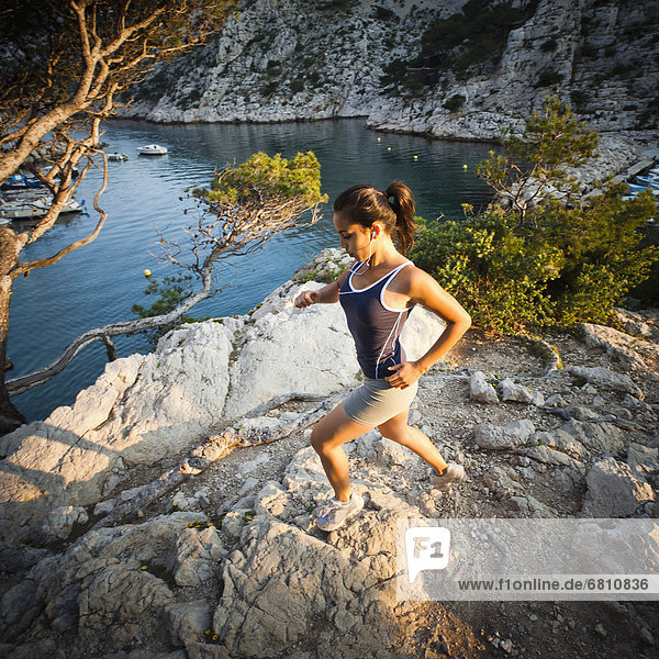 France  Marseille  Young woman jogging in rocky terrain