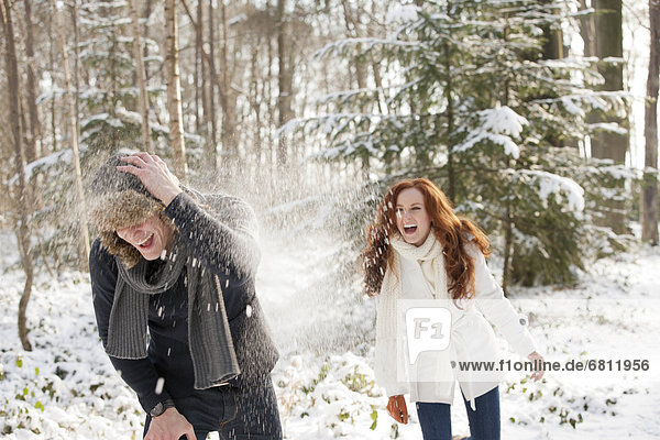 Young couple are having snowball fight
