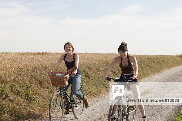 France  Picardie  Albert  Young women on bikes on country road