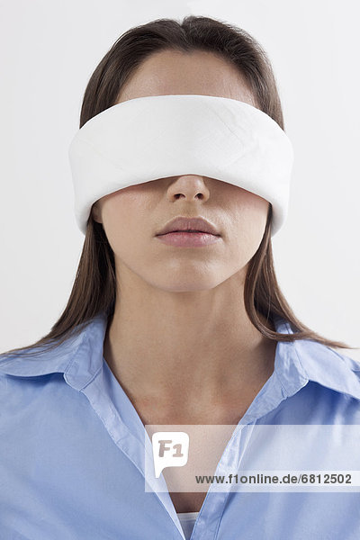 Studio shot of woman wearing blindfold