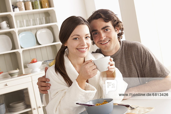 Portrait of young couple at breakfast