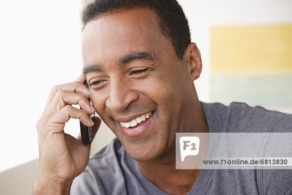 Portrait of smiling mature man talking via mobile