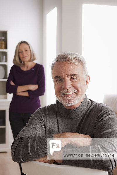 Portrait of smiling senior man  senior woman in background
