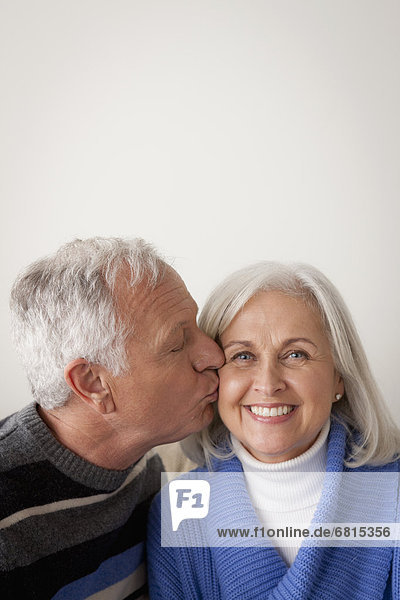 Senior couple  man kissing woman