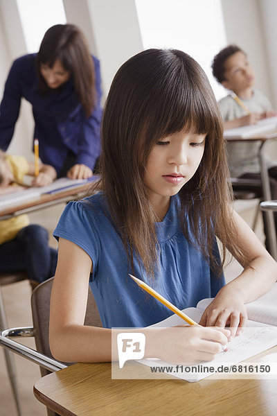 Schoolgirl focused on writing