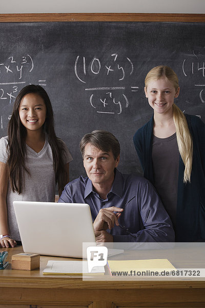 Portrait of maths teacher with two students (14-15)