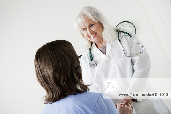 Senior doctor talking with patient