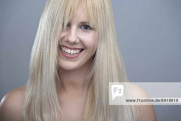 Portrait of young woman with blonde hair  studio shot