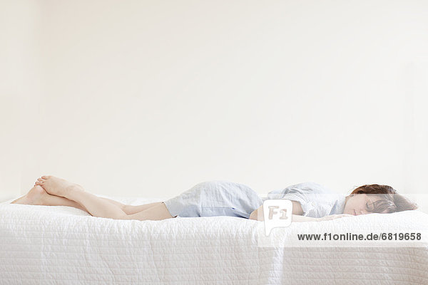 Attractive young woman sleeping in bed