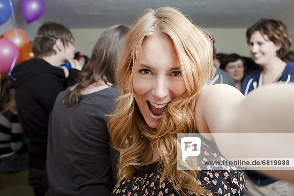 Self portrait of young woman at party