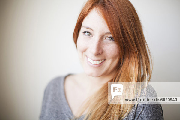Portrait of attractive young woman with dyed redhead