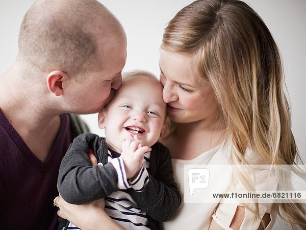 Portrait of happy young family with baby boy (12-17 months)