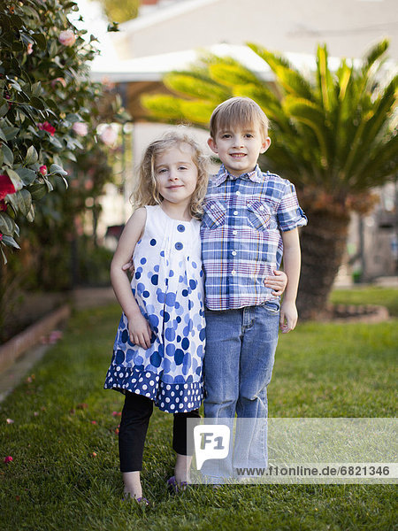 Outdoor portrait of girl (4-5) and boy (6-7)