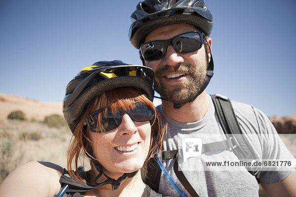 Outdoors portrait of couple in cycling gear