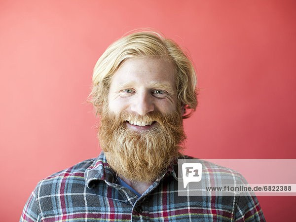 Portrait of smiling man with beard  studio shot