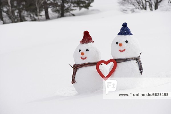 Snowman couple with heart shape  Yamagata Prefecture  Japan.