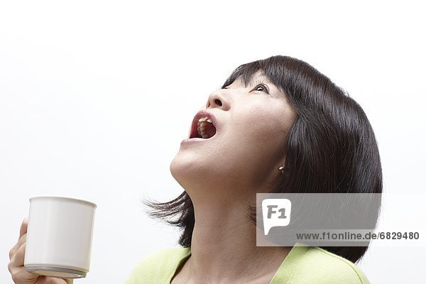 Woman gargling with mouthwash