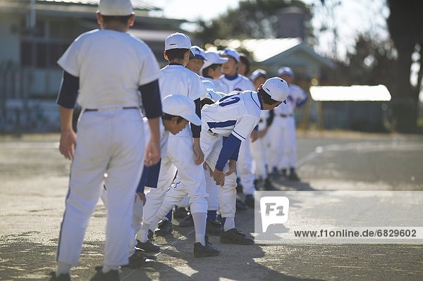 Boys in baseball uniform lined up