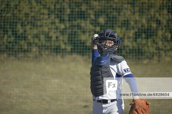 Baseball catcher throwing a ball
