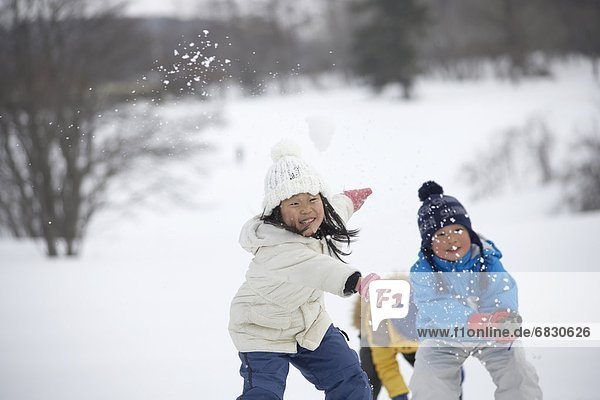 Three kids playing in snow